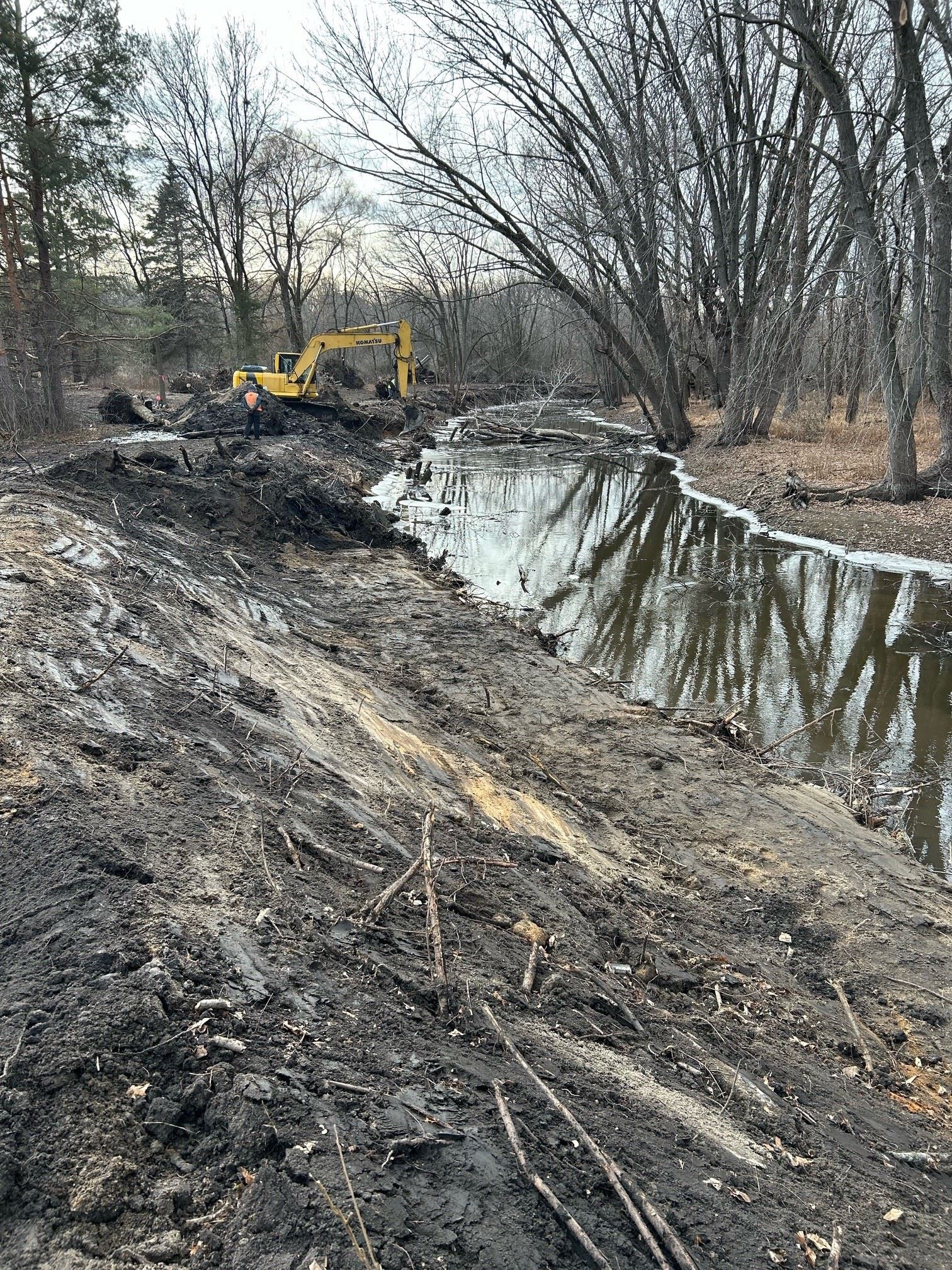 An image of the stream with an excavator
