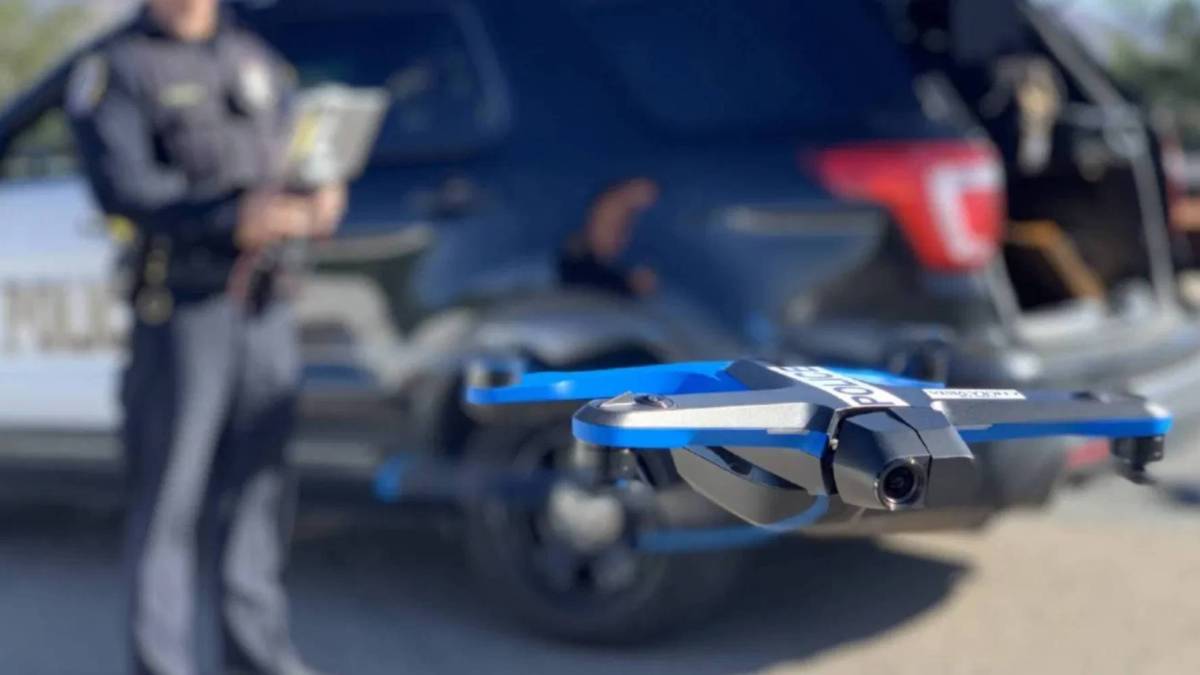 A police officer is flying a public safety drone.